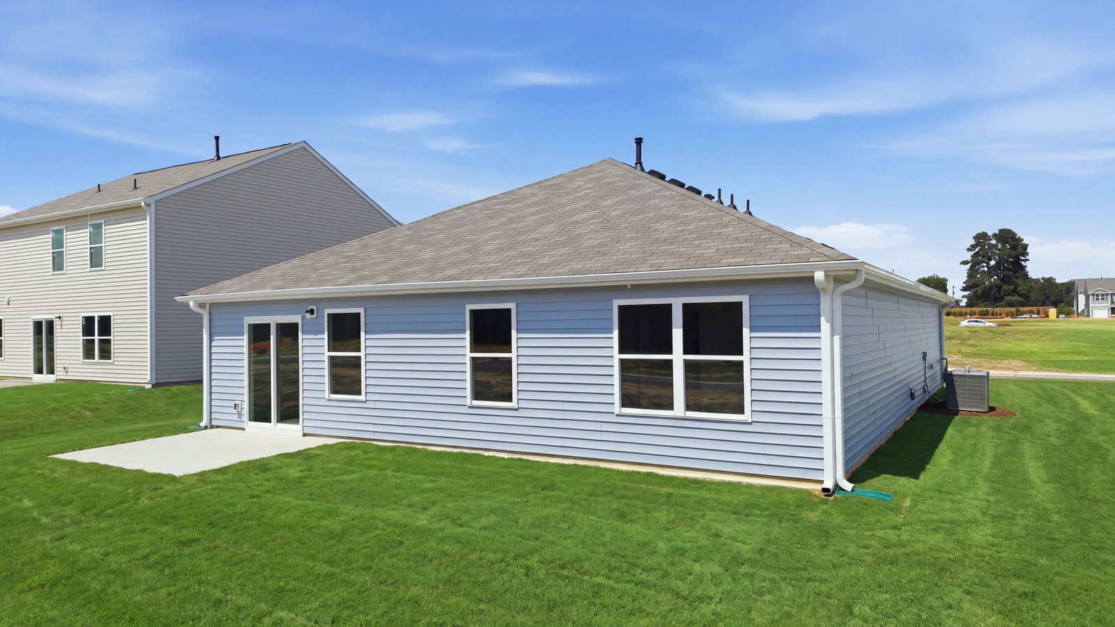 rear view of home and back yard with back patio pad