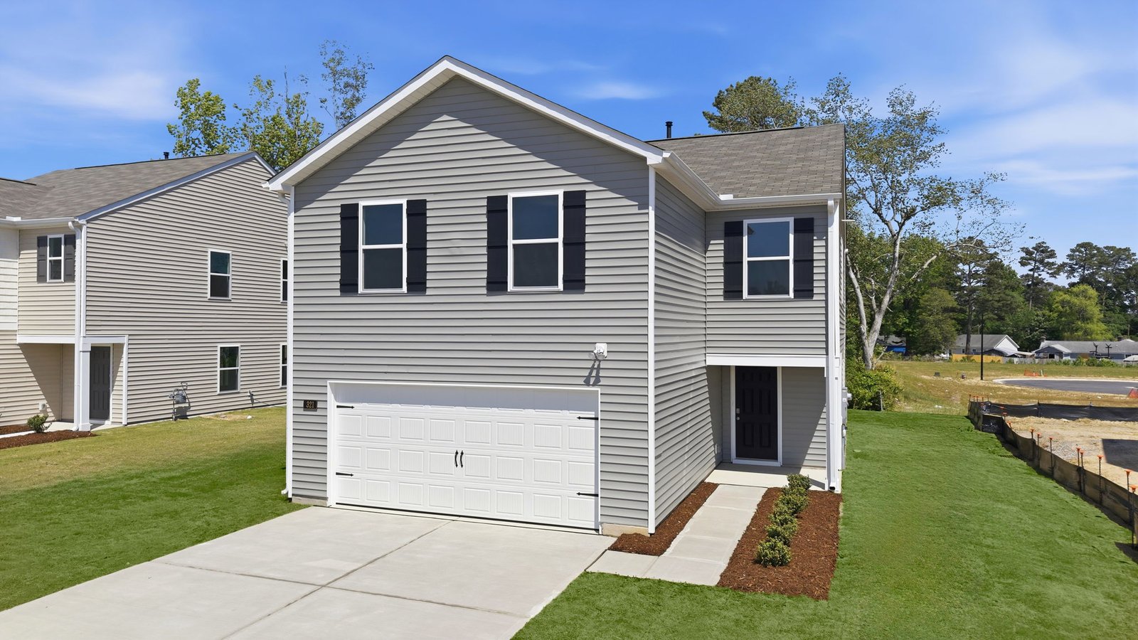two story grey home with two car garage