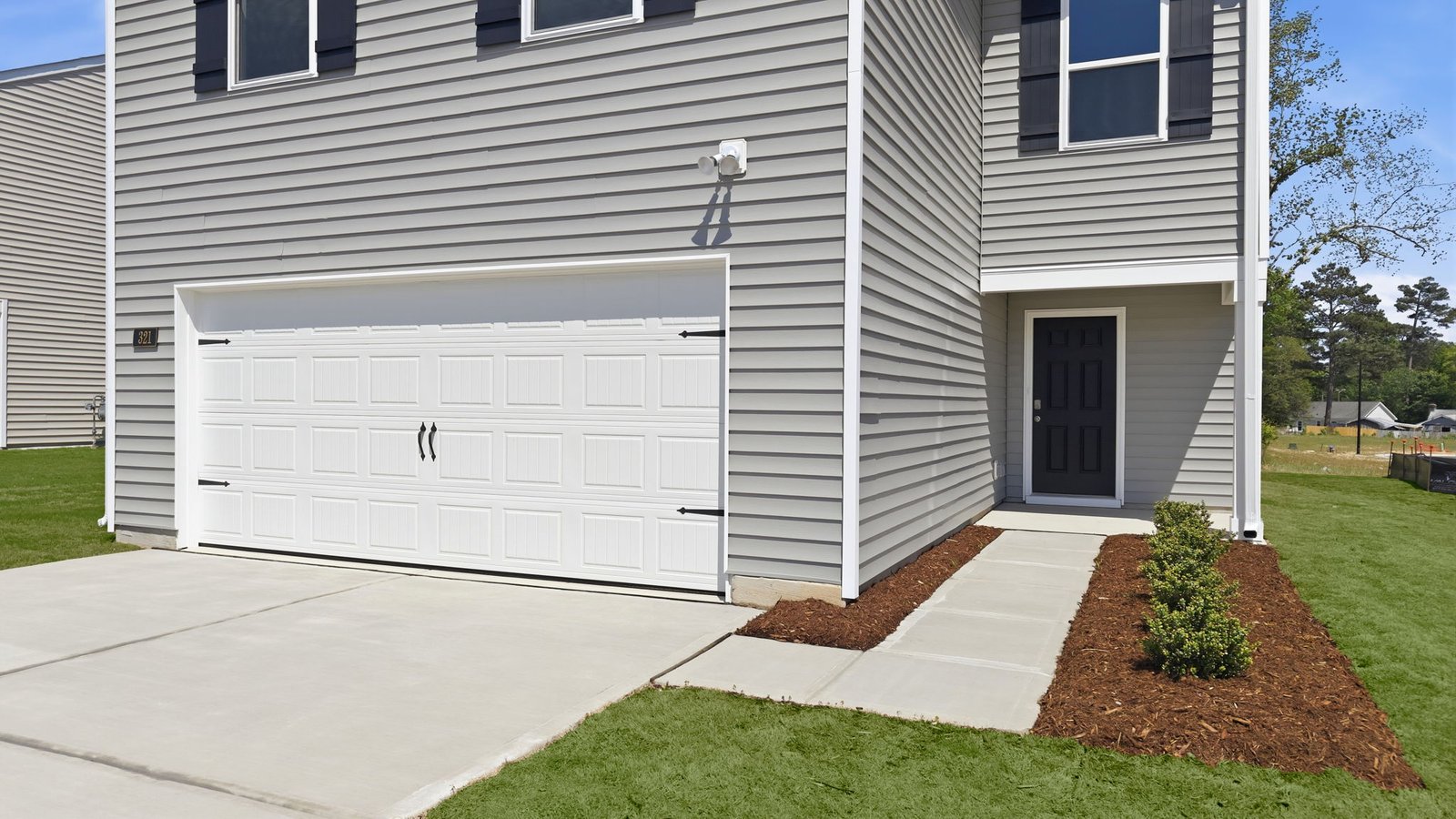 view of the two car garage and covered porch
