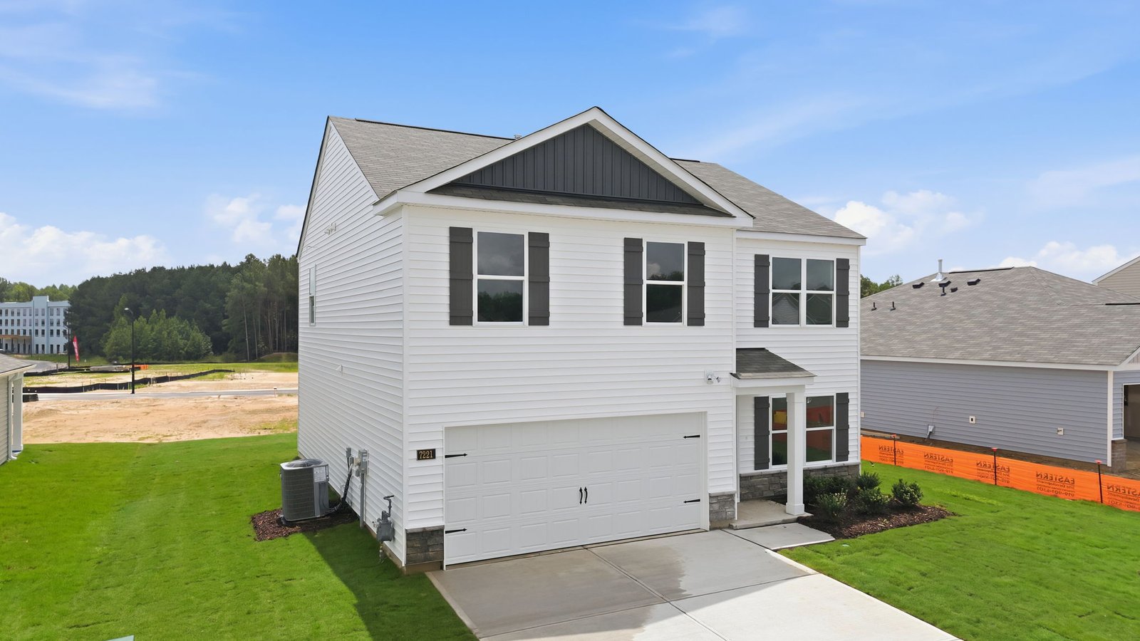 two story home with two car garage and driveway