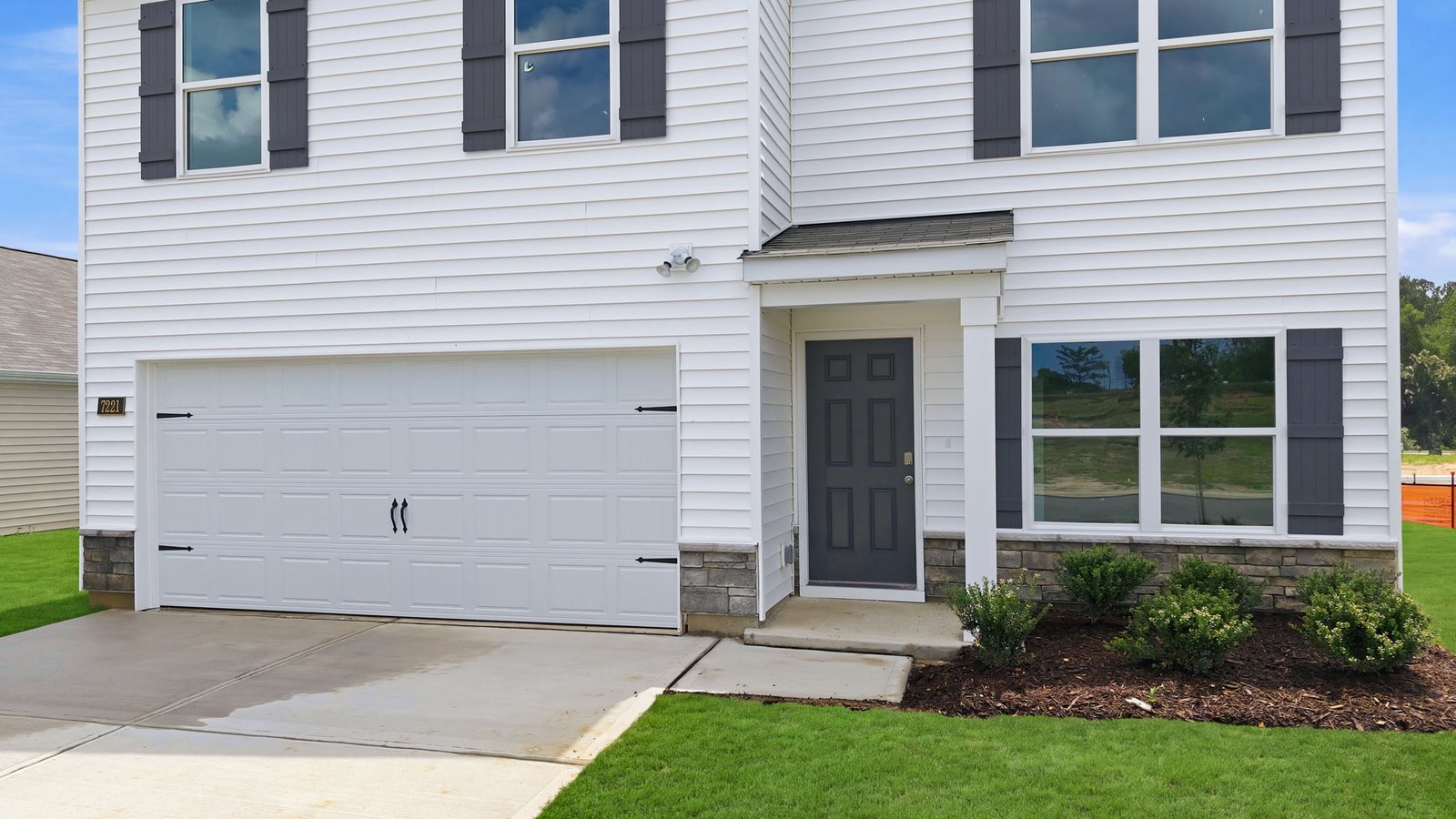 front porch and garage view of home