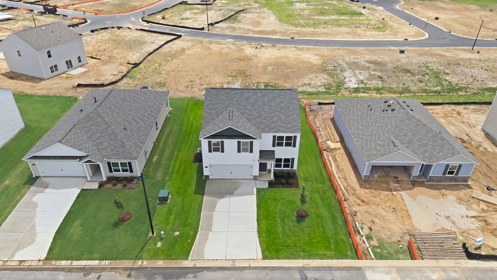 aerial view of home with driveway view and yard