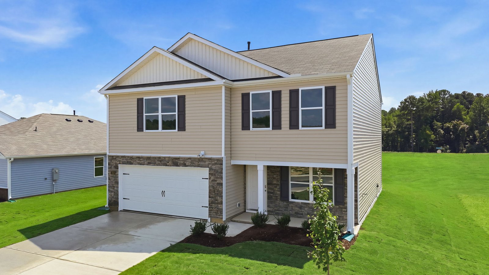 exterior of two story home with brick and vinyl and two car garage