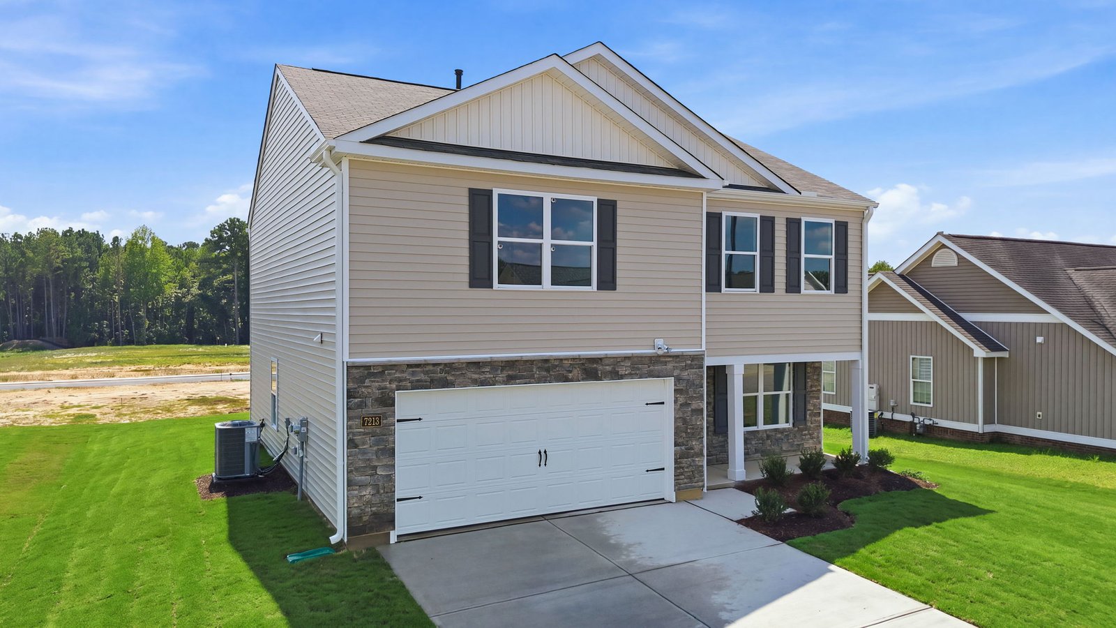 exterior of two story home with brick and vinyl and two car garage