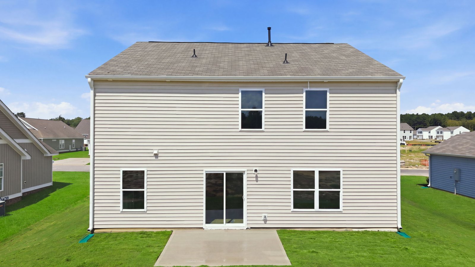 rear view of home and back patio pad