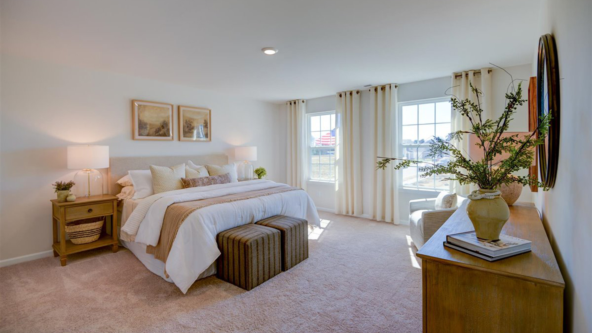 Large primary bedroom with windows.
