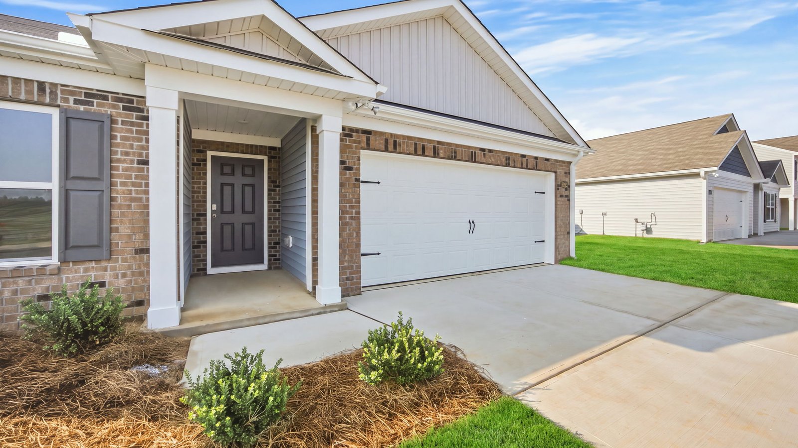 front view of home with driveway and two car garage