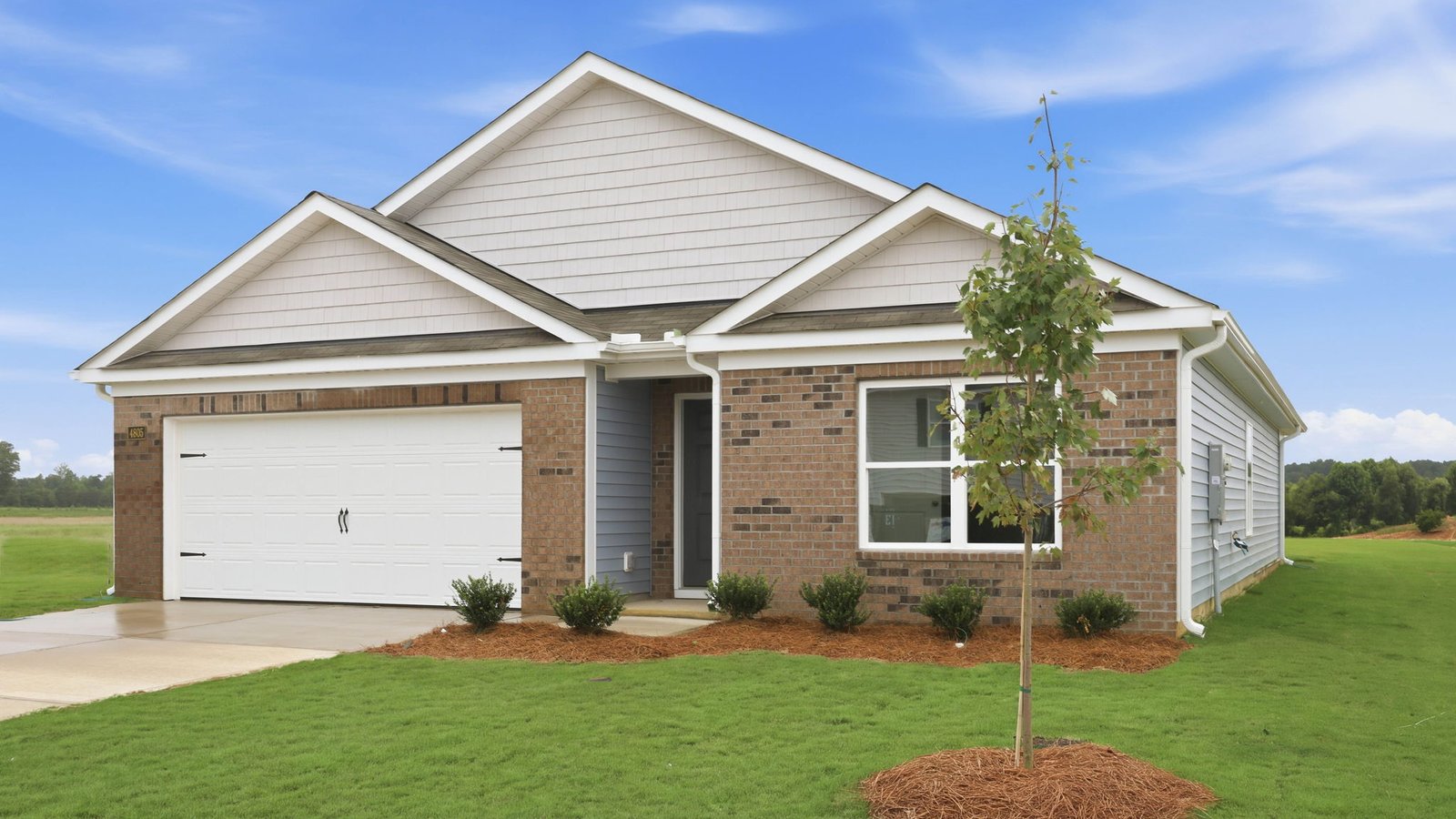 one story brick and vinyl home with two car garage