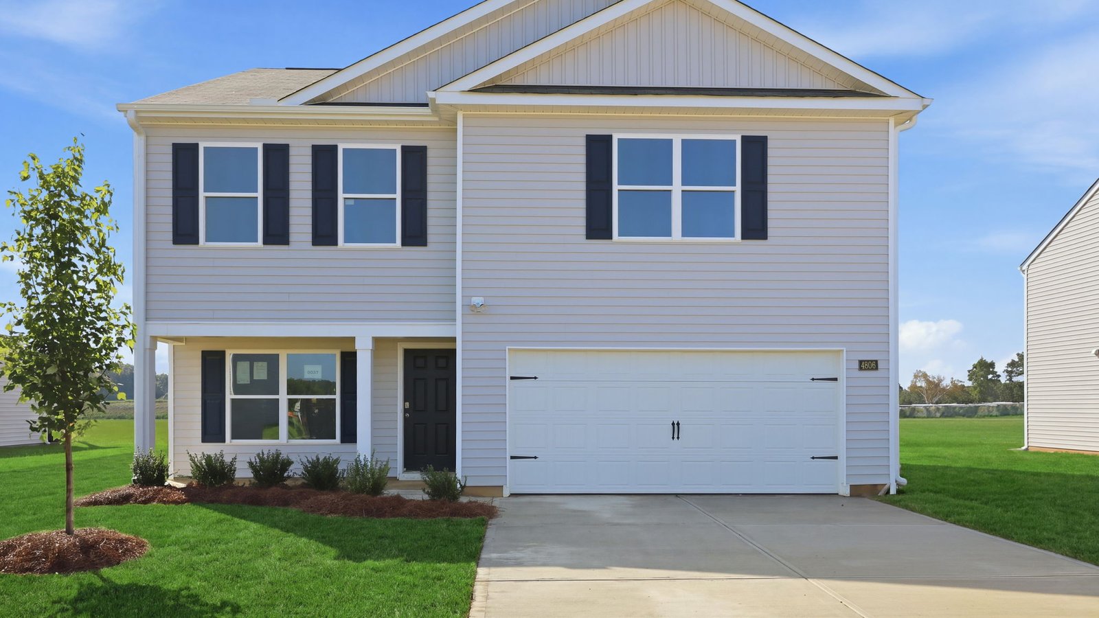 exterior of two story home with vinyl and two car garage