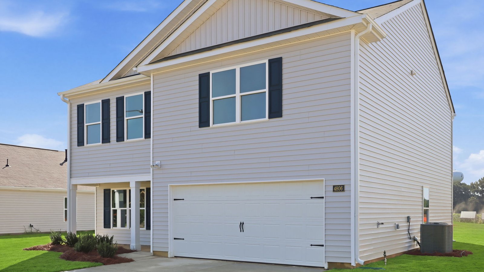 exterior of two story home with vinyl and two car garage