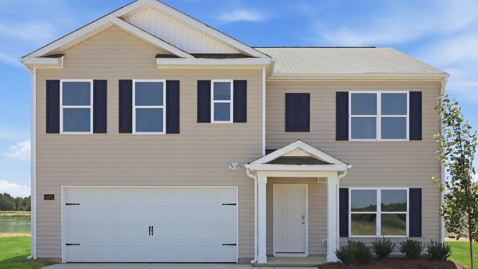 exterior of two story vinyl home with two car garage