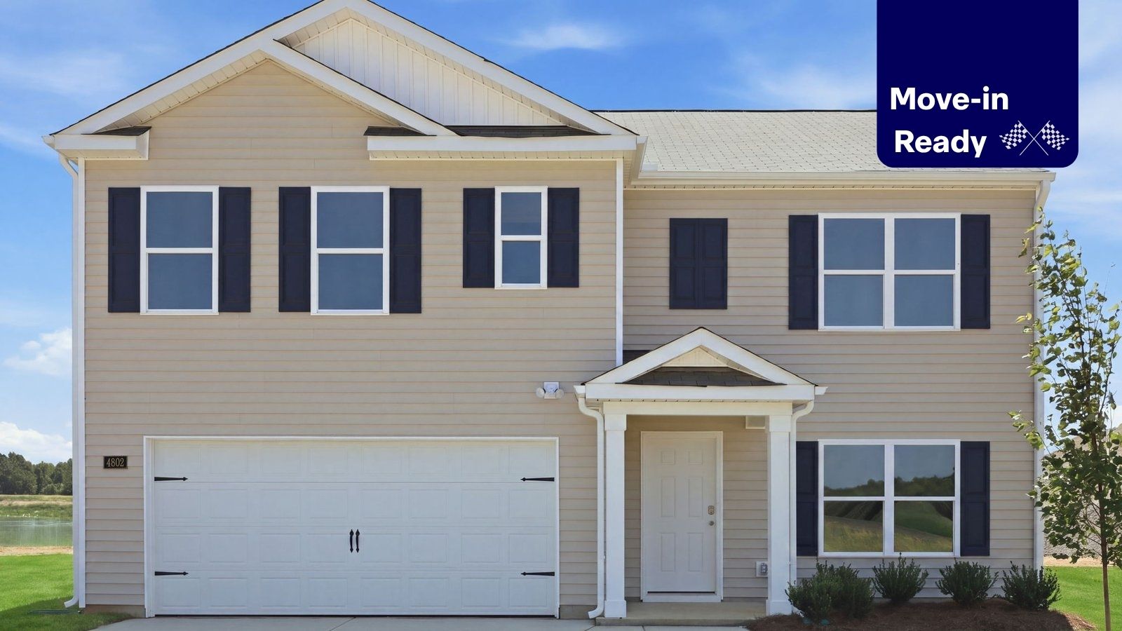 exterior of two story vinyl home with two car garage