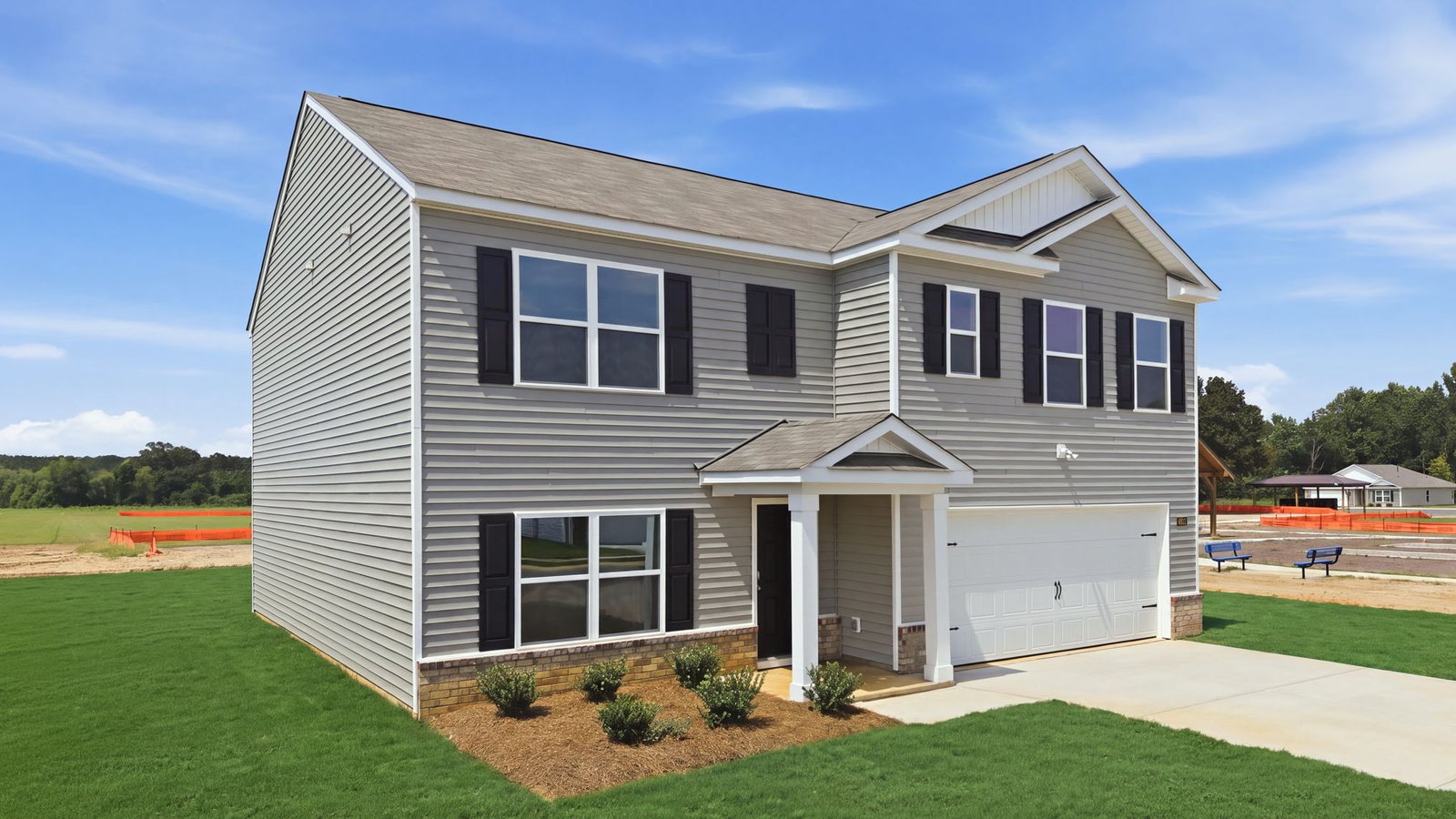 exterior of home with two car garage and yard view
