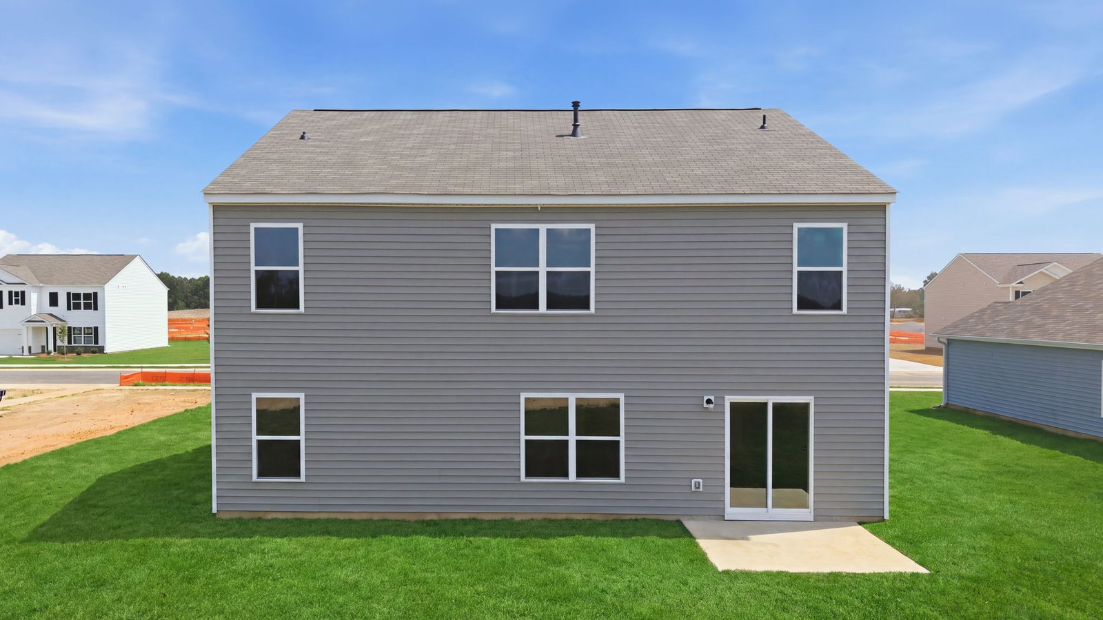 rear view of home with back yard and back patio pad