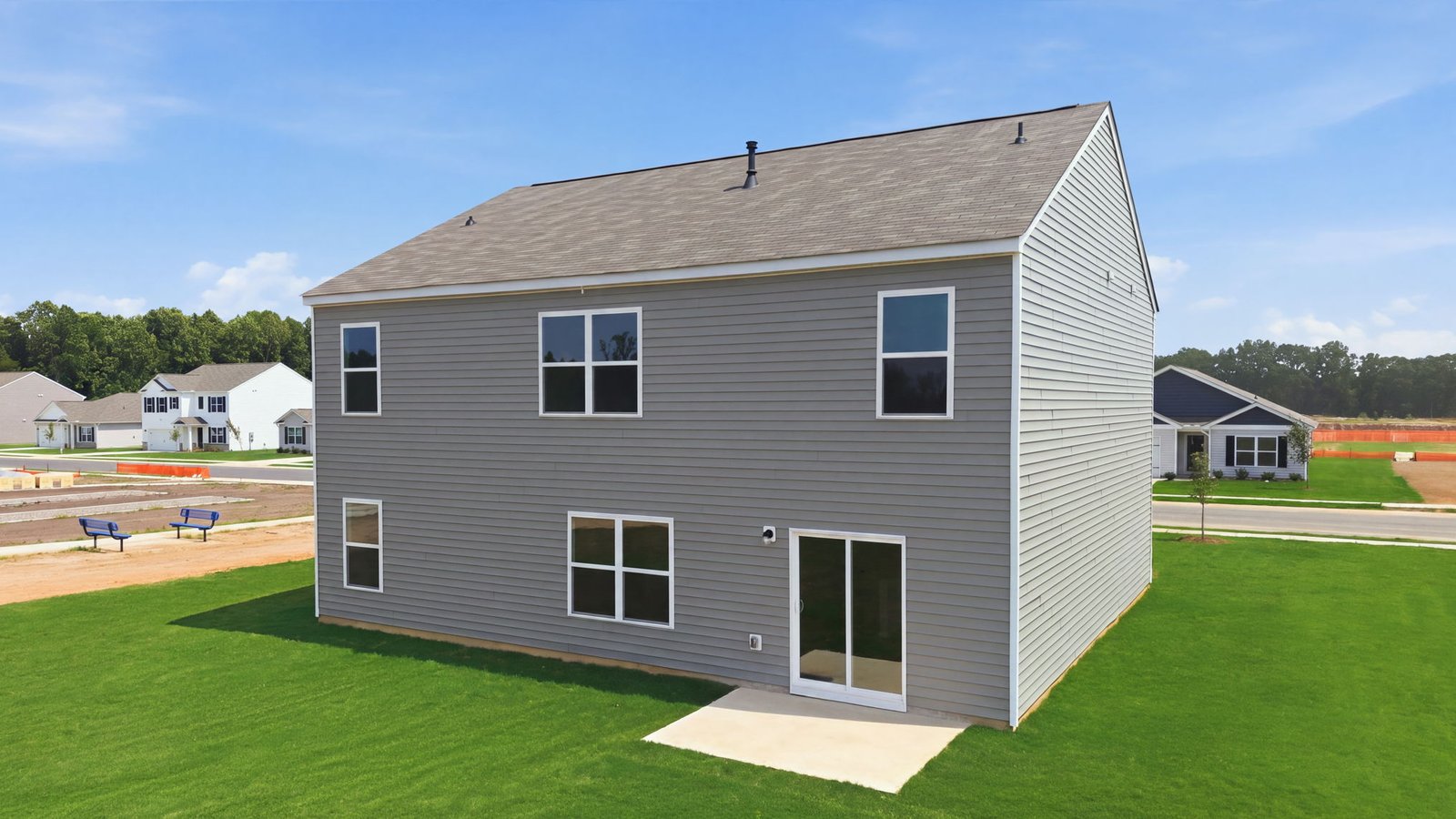 rear view of home with back yard and back patio pad