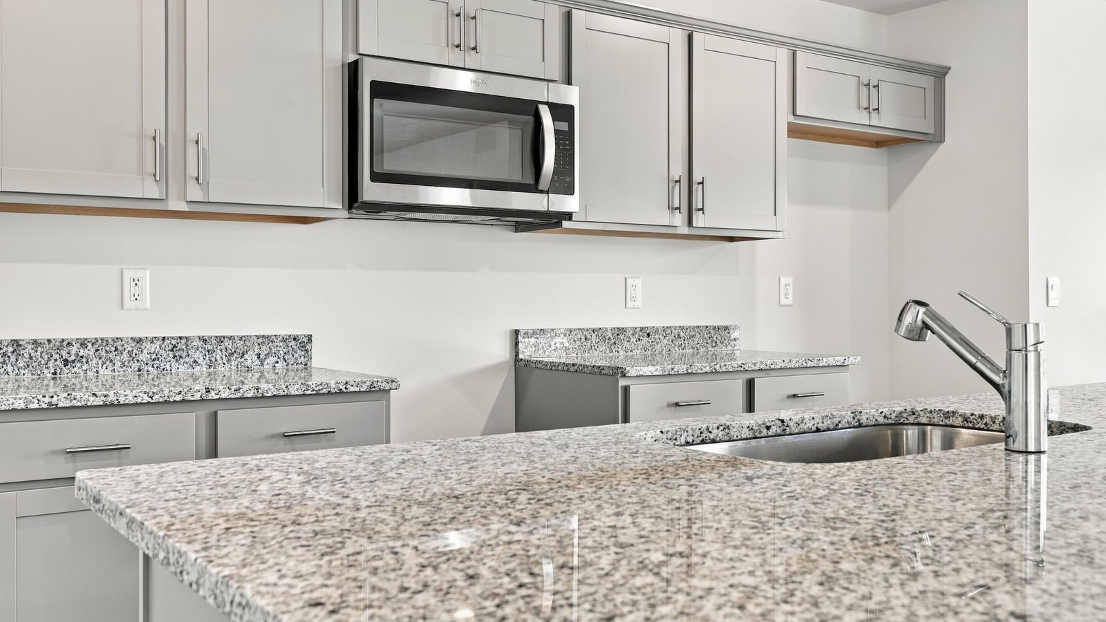 kitchen area with island and stainless steel appliances