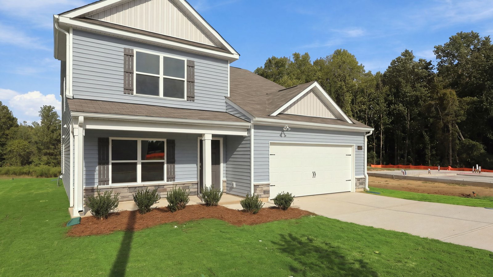 exterior of blue home with two car garage