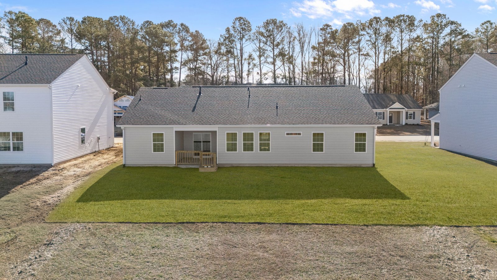 rear view of home with backyard view