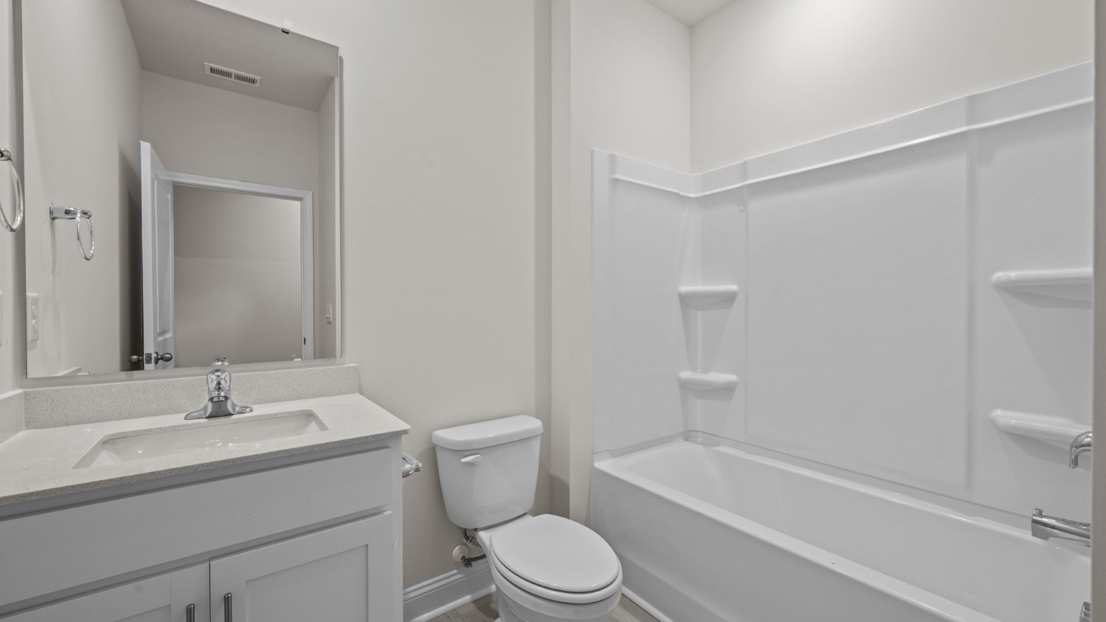 bathroom with white cabinets and tub and shower