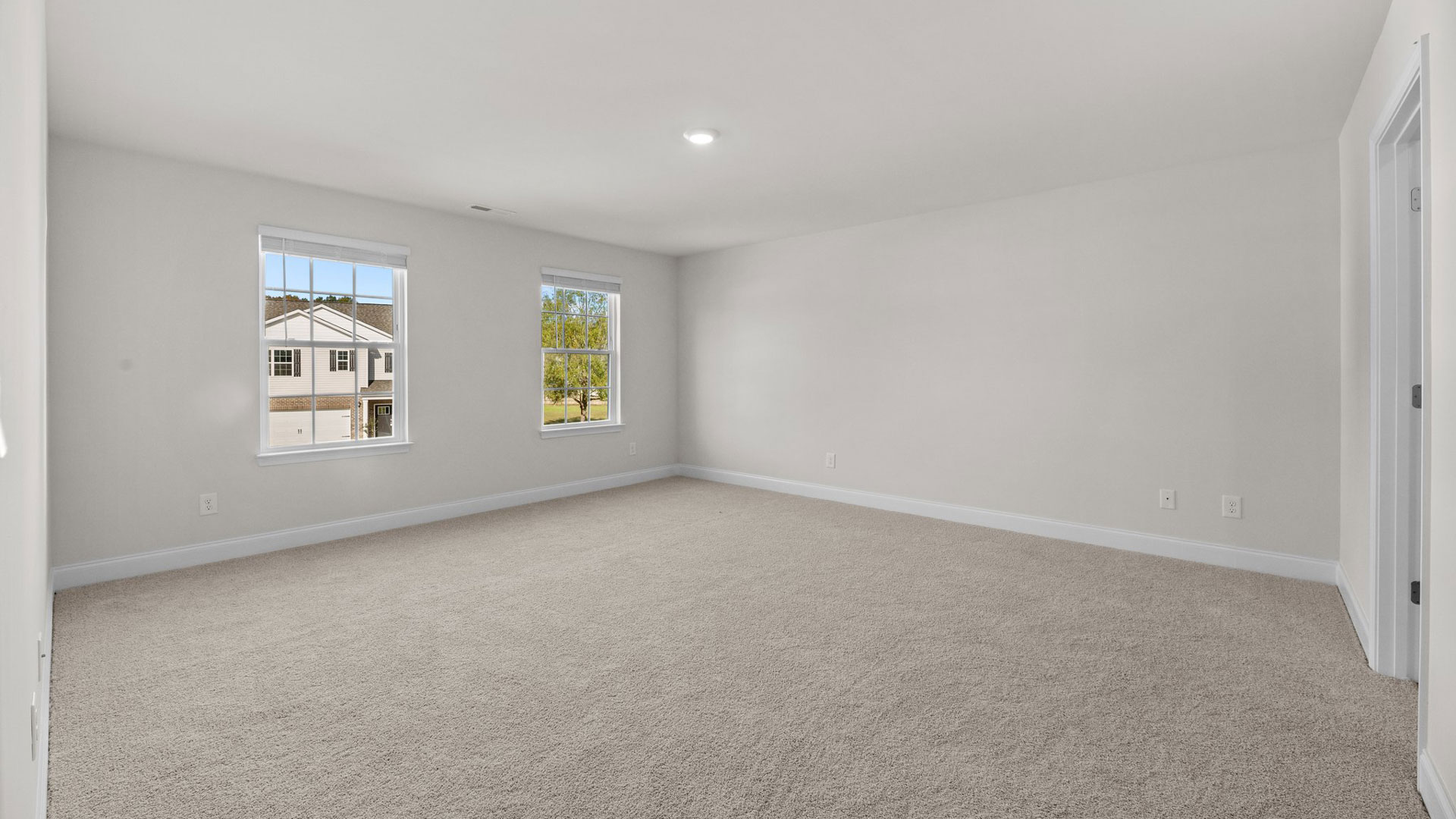Primary bedroom with carpet flooring