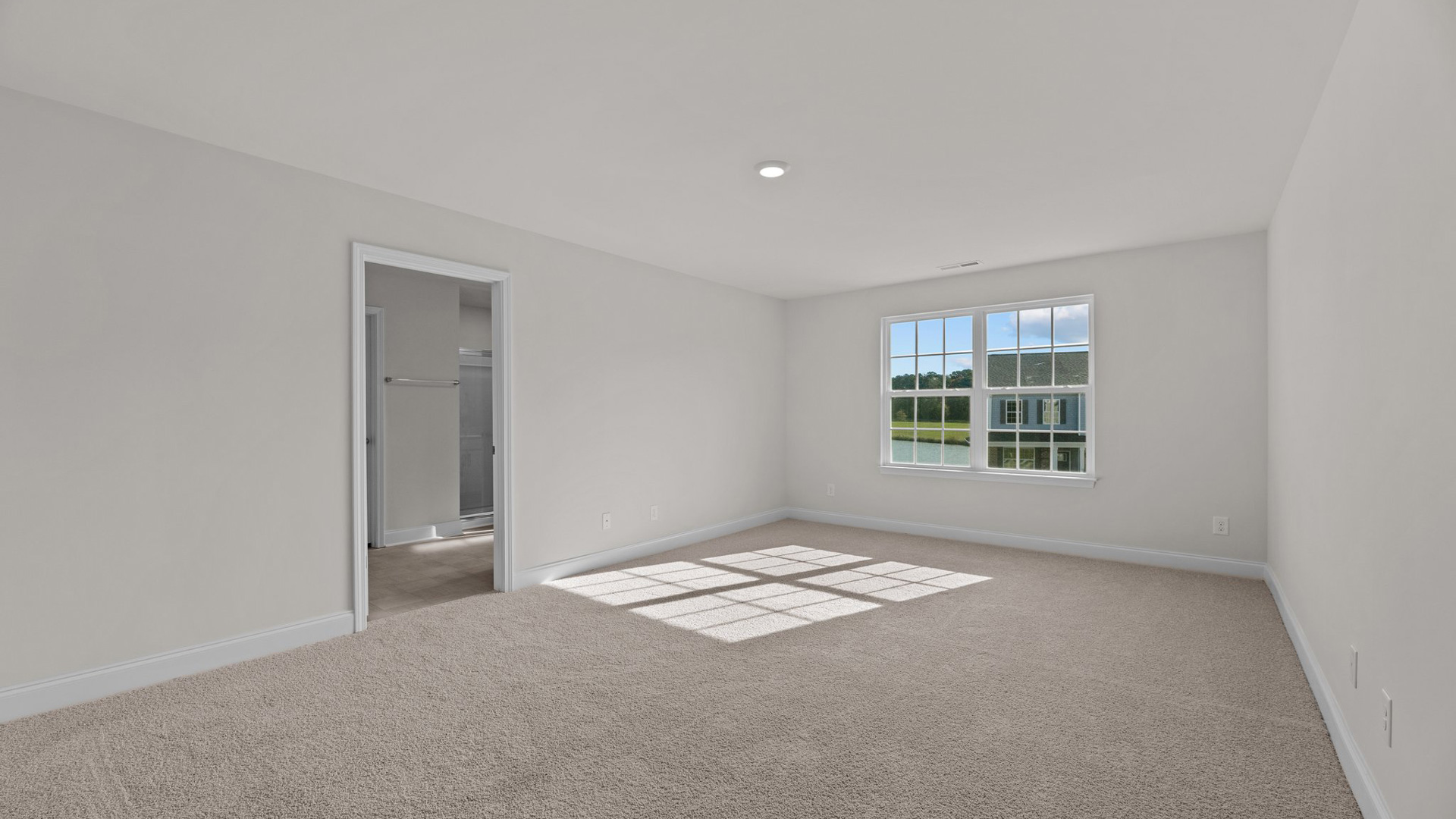 Primary bedroom with carpet flooring