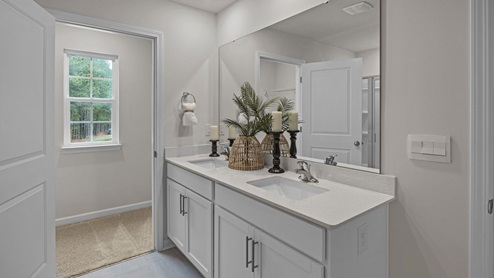 Bathroom with quartz counters and a walk in shower
