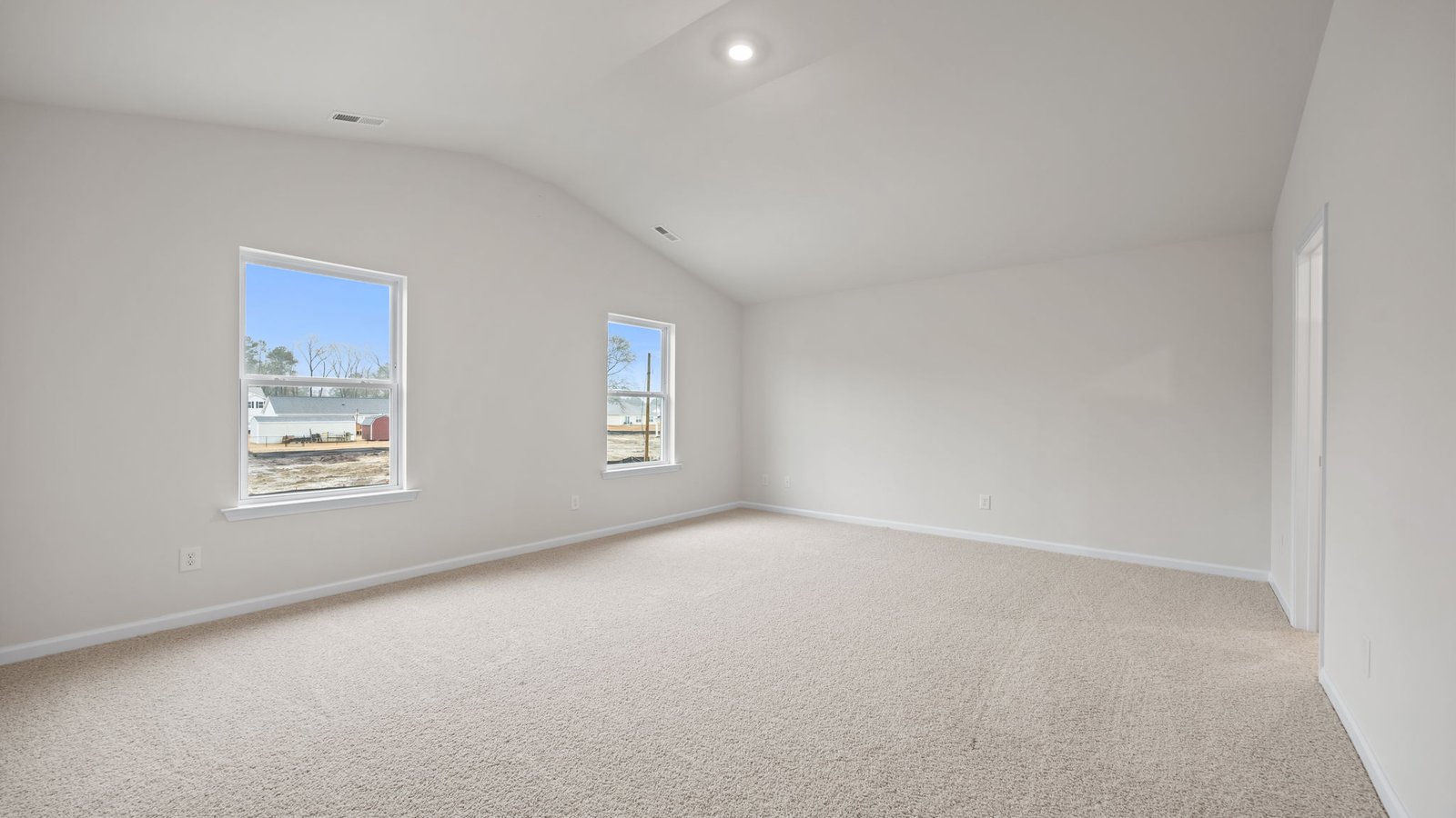 primary bedroom with vaulted ceiling