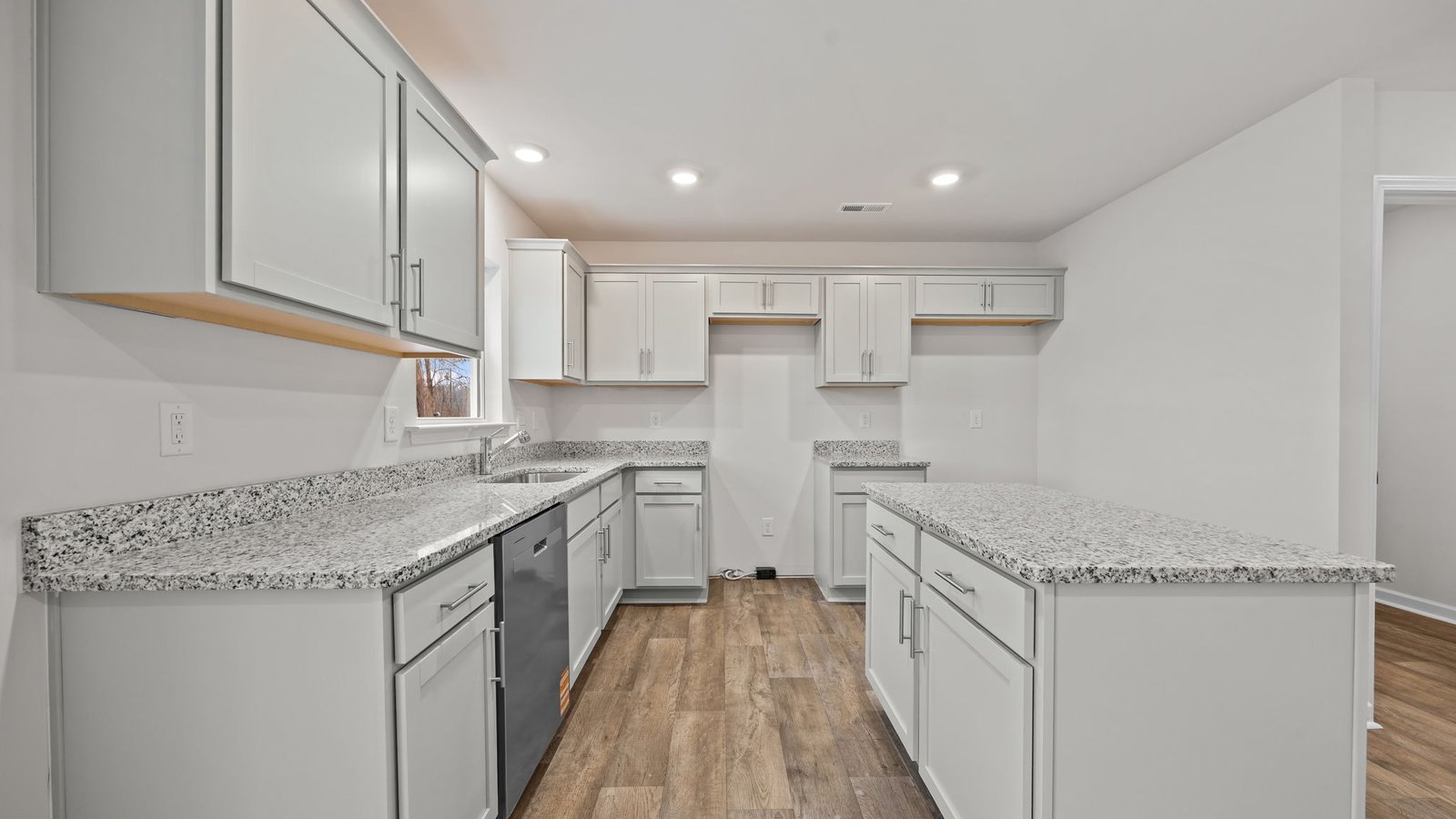 kitchen is island and stainless steel appliances