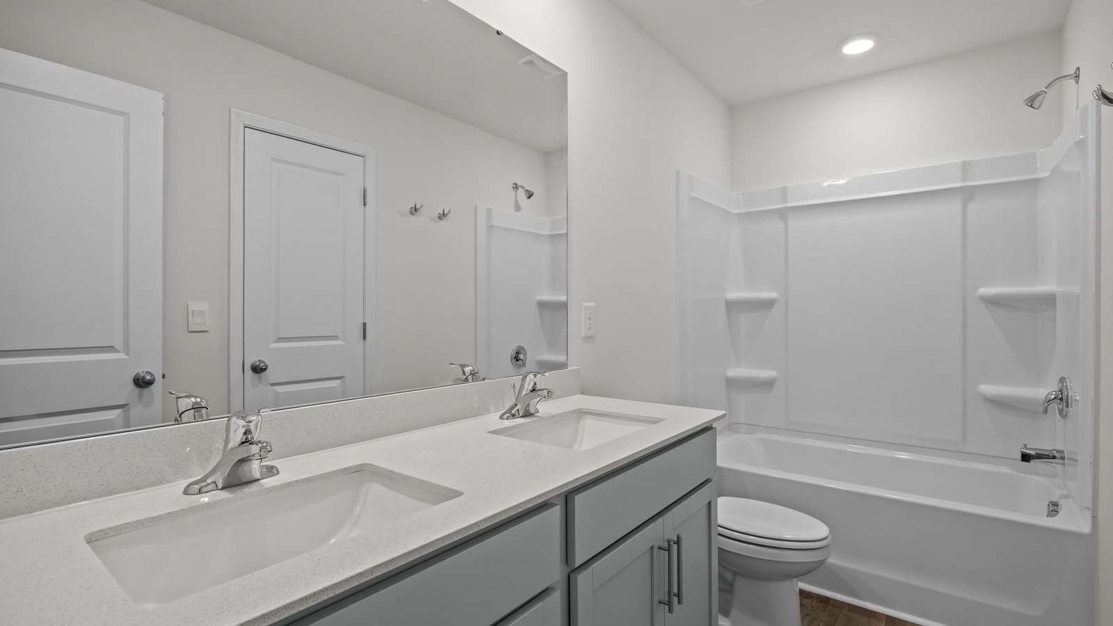 full bath with double vanity and tub/shower combo