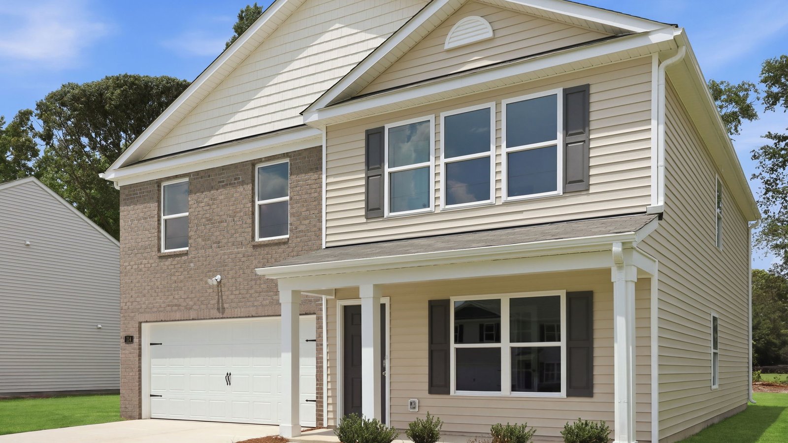 exterior of two story brick and vinyl home kyle floorplan with covered front porch