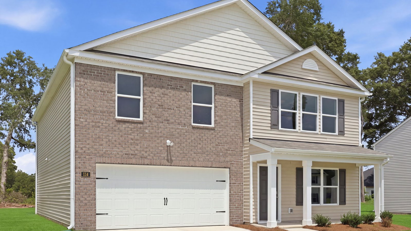 exterior of the home with two story brick and vinyl