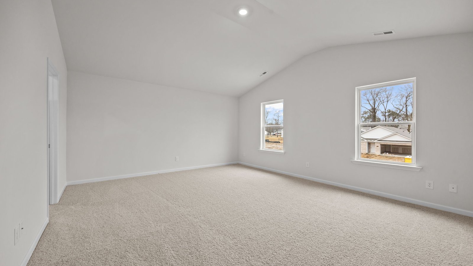primary bedroom with vaulted ceilings