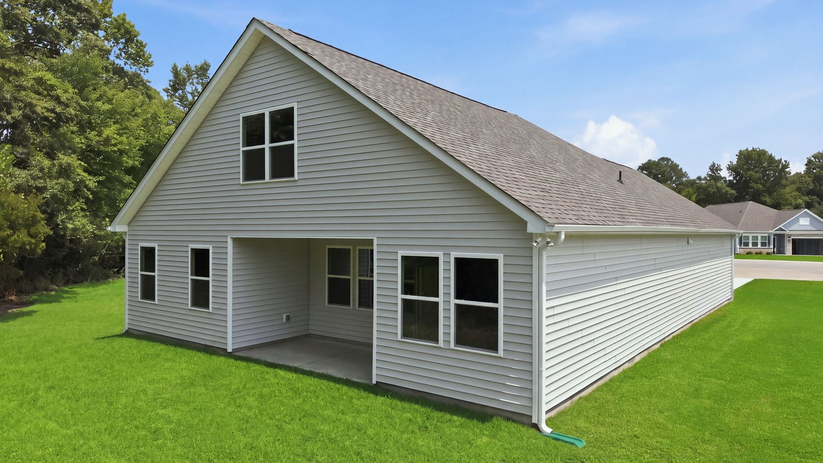 rear view of the home and yard