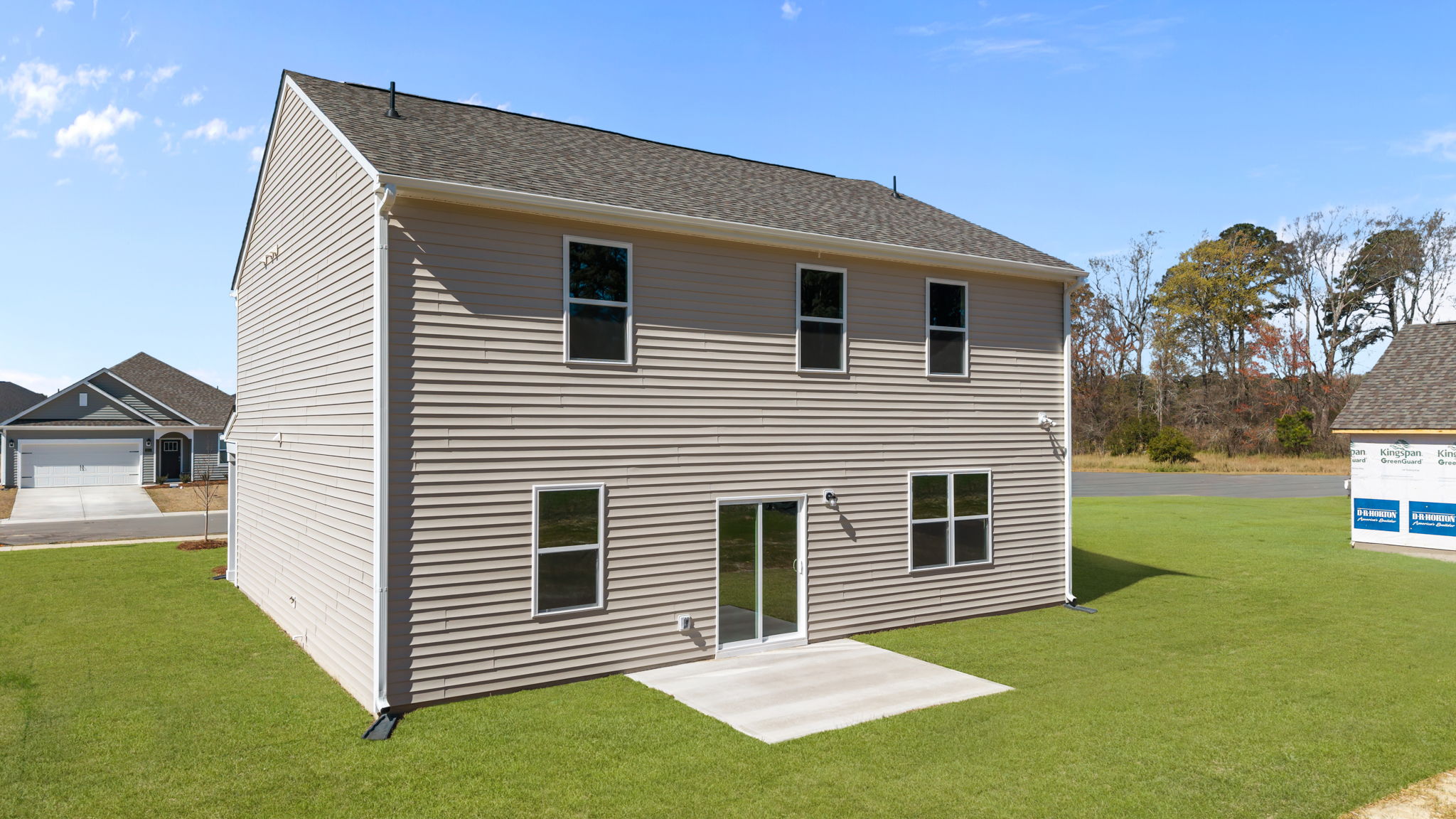 Exterior rear of the home featuring back patio pad