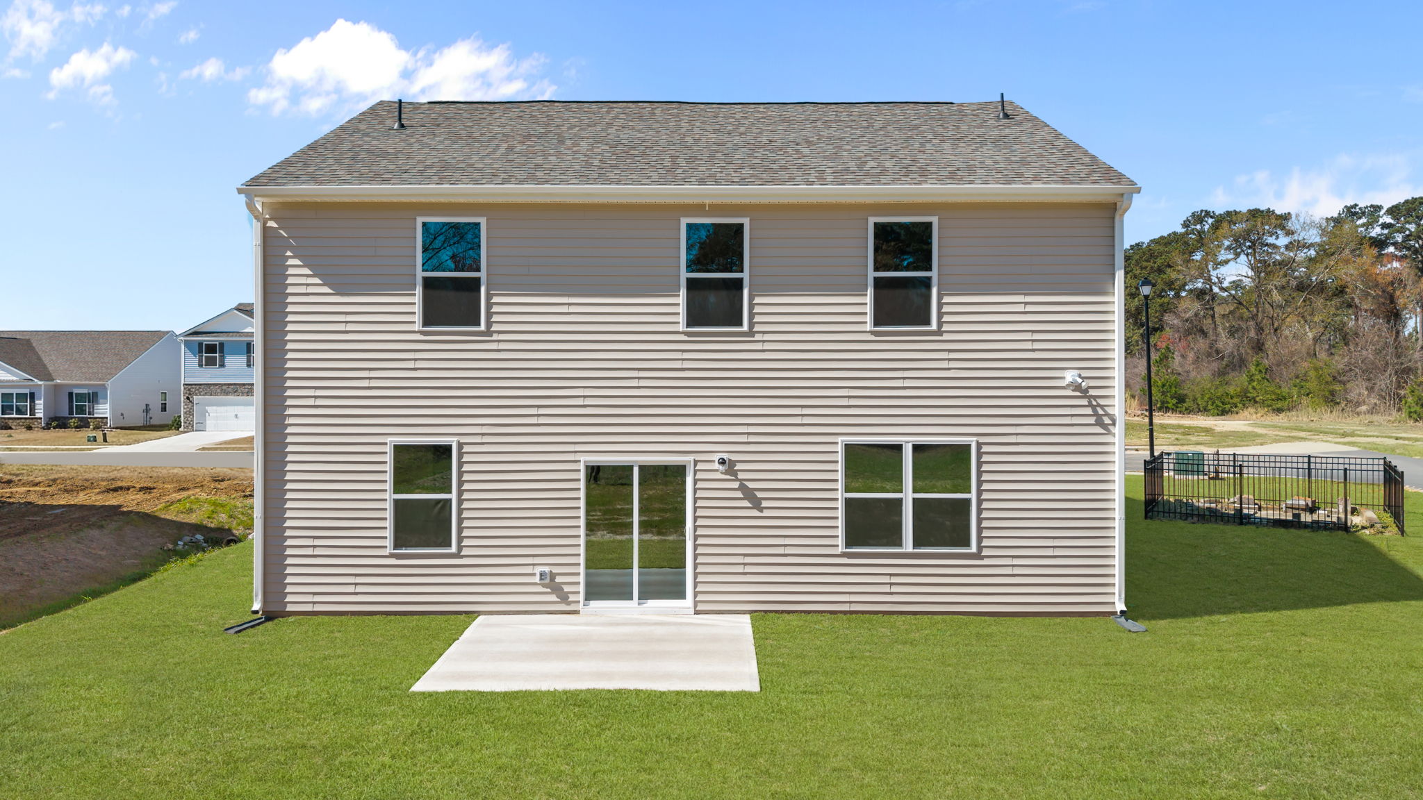 Rear view of the home with a back patio pad