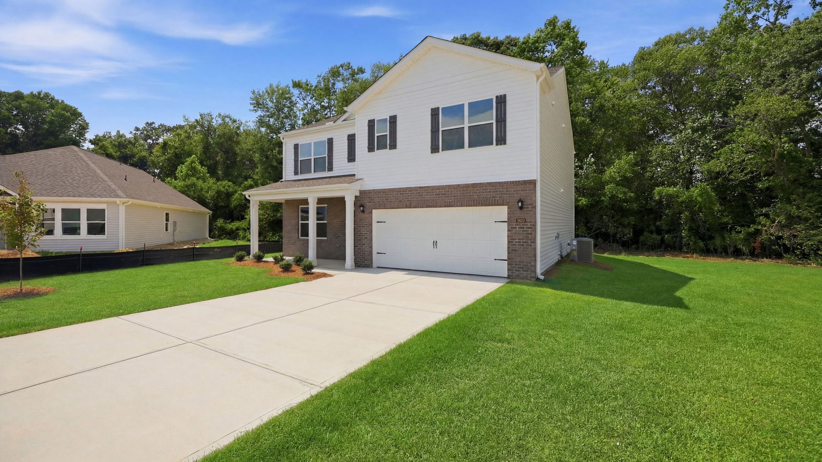 front view of hayden with driveway and two car garage