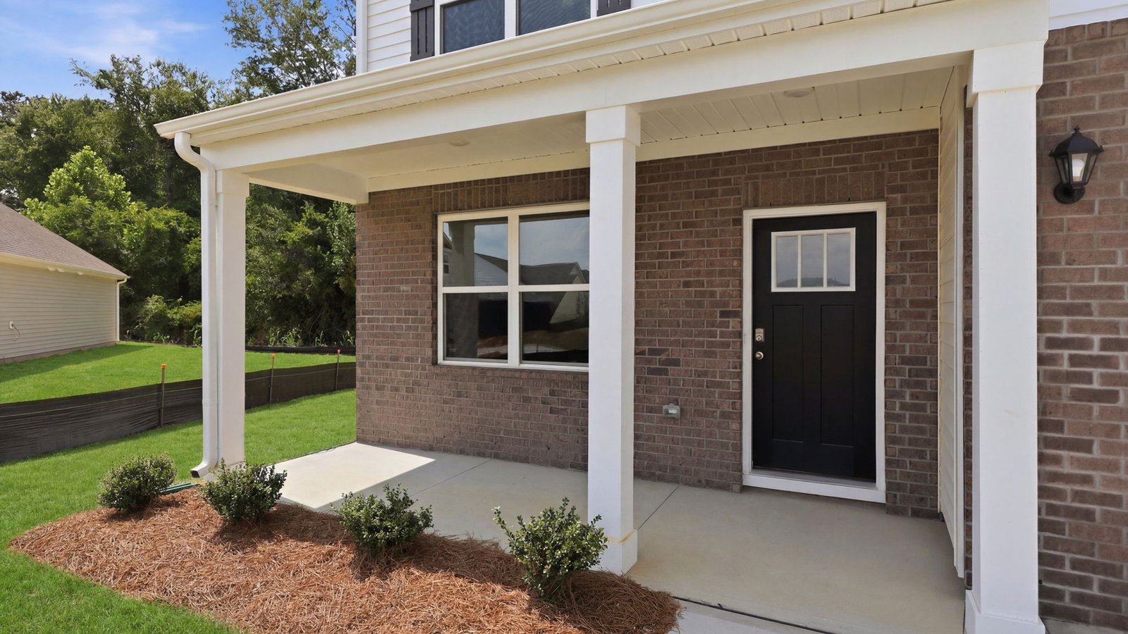 view of covered front porch on hayden two story brick and vinyl home
