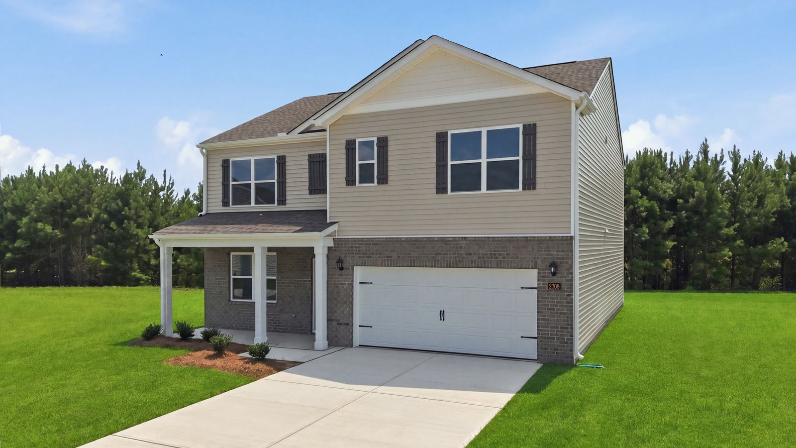 two story home with front driveway and two car garage