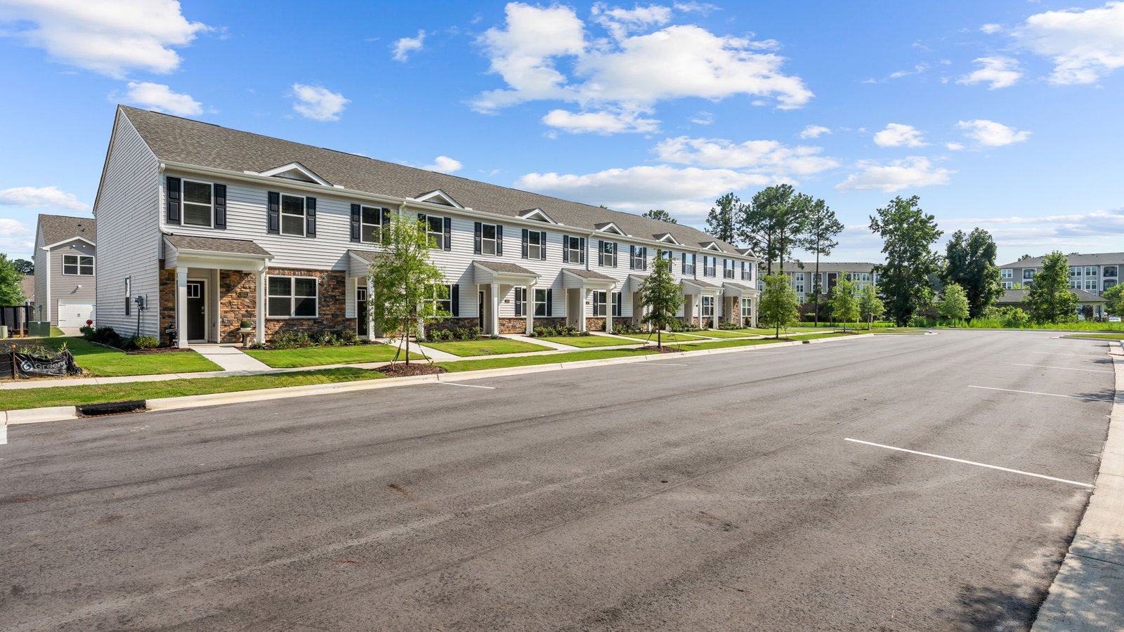 Two story townhomes with brick and vinyl and one car garage