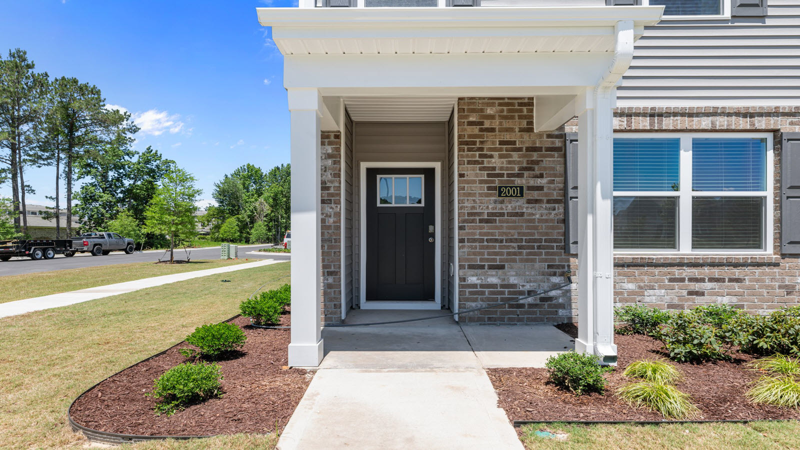 front door of home featuring a covered front porch