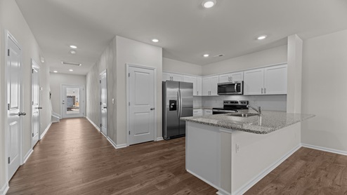 kitchen with white cabinetry, large island and stainless steel appliances