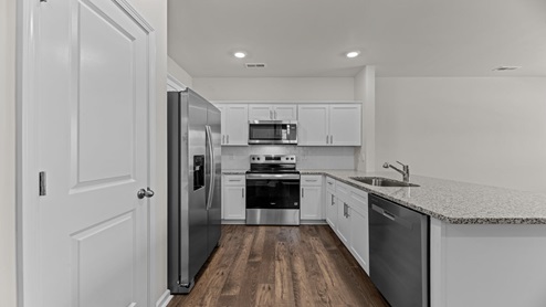 kitchen with white cabinetry, large island and stainless steel appliances