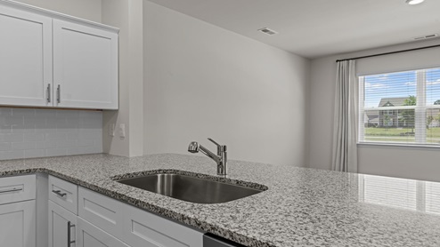 kitchen with white cabinetry, large island and stainless steel appliances