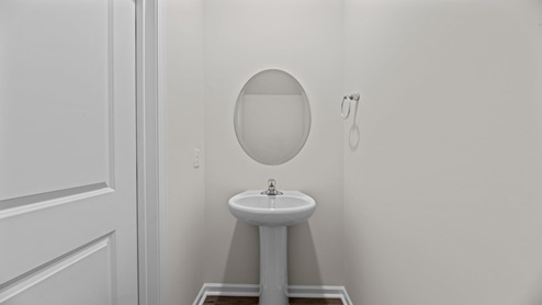 powder bathroom with a pedestal sink