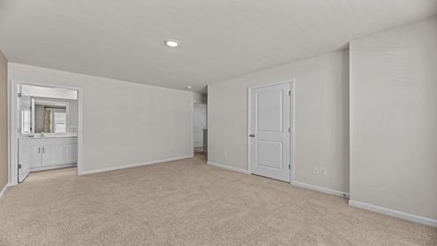 bedroom with light beige carpet and walls with a large window