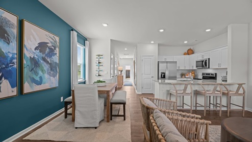 open space concept area featuring dining area and kitchen