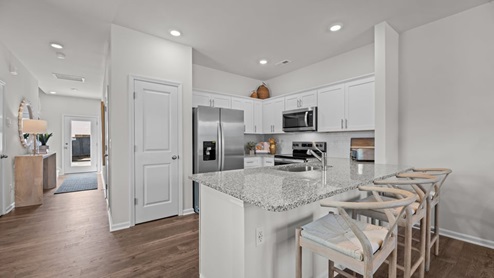 open space concept area featuring kitchen and living room