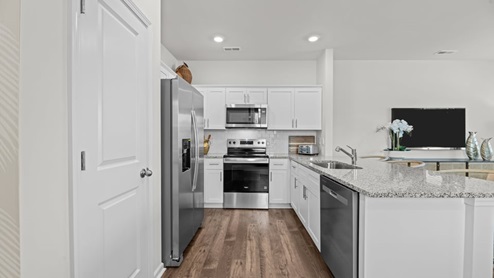 view of kitchen with white cabinets and stainless steel appliances