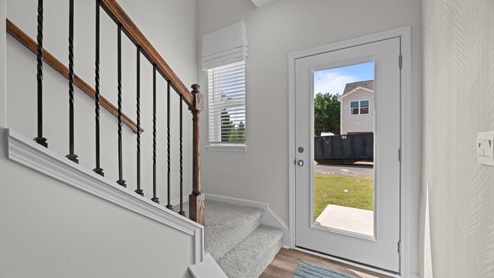 view of entry way featuring the staircase and front door