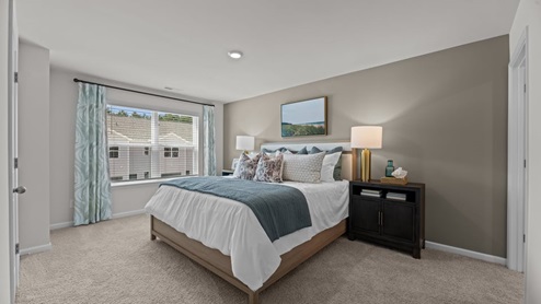 primary bedroom featuring carpet and large window